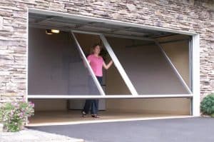 Woman walks through retractable garage door screen