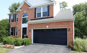 Black Garage Doors on Red Brick House